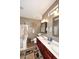 Well-lit bathroom with double vanity, decorative wall art, and glass-enclosed shower at 10916 E Cholla Rd, Mesa, AZ 85207