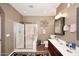 Bathroom features a shower, sink, toilet and decorative mirror at 10916 E Cholla Rd, Mesa, AZ 85207
