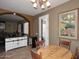 Cozy dining area with wood table, archway, and views into the living room and backyard at 10916 E Cholla Rd, Mesa, AZ 85207