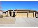 Charming single-story home featuring a three-car garage and a desert-landscaped front yard at 10916 E Cholla Rd, Mesa, AZ 85207
