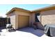 Exterior view of the attached garage and a well-maintained side yard at 10916 E Cholla Rd, Mesa, AZ 85207