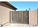 Wooden gate between two stucco walls at 10916 E Cholla Rd, Mesa, AZ 85207