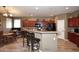 A spacious kitchen features wood cabinets, an island with bar stool seating, and modern appliances at 10916 E Cholla Rd, Mesa, AZ 85207
