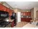 A kitchen featuring wood cabinets, stainless steel appliances and a tile floor at 10916 E Cholla Rd, Mesa, AZ 85207