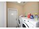 A laundry room with stacked washer and dryer at 10916 E Cholla Rd, Mesa, AZ 85207