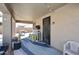 Relaxing covered patio with outdoor furniture, a bar area, and stylish lighting at 10916 E Cholla Rd, Mesa, AZ 85207