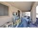 Inviting covered patio with a cozy bar area, TV, and comfortable seating at 10916 E Cholla Rd, Mesa, AZ 85207