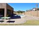 Backyard featuring a refreshing swimming pool, large patio, and manicured landscaping at 10916 E Cholla Rd, Mesa, AZ 85207