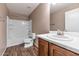 Well-lit bathroom with wood-look flooring and a pristine white shower-tub at 10938 W Pierson St, Phoenix, AZ 85037