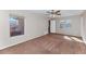 Bright bedroom with multiple windows and neutral carpet flooring at 10938 W Pierson St, Phoenix, AZ 85037