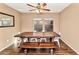 Bright dining room with a rustic wooden table, seating for eight, laminate floors and natural light from the windows at 10938 W Pierson St, Phoenix, AZ 85037