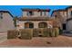 Charming two-story home featuring a tile roof, arched entryway, and well-maintained landscaping in a residential neighborhood at 10938 W Pierson St, Phoenix, AZ 85037