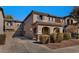 Inviting two-story home with an attached two-car garage, tile roof, and a charming arched entryway with manicured landscaping at 10938 W Pierson St, Phoenix, AZ 85037