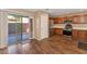 Charming kitchen features wood cabinets, stainless steel appliances, laminate floors and sliding door access to outdoor patio at 10938 W Pierson St, Phoenix, AZ 85037