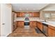 Well-equipped kitchen with stainless steel appliances, wood cabinets, and ample counter space for cooking and food preparation at 10938 W Pierson St, Phoenix, AZ 85037