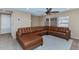 Comfortable living room featuring a plush brown sectional sofa and neutral-toned decor at 10938 W Pierson St, Phoenix, AZ 85037