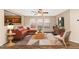 Cozy living room with a comfortable sofa, stylish rug, and ample natural light streaming through the multiple windows at 10938 W Pierson St, Phoenix, AZ 85037
