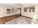 Inviting living room with laminate flooring, natural light from large windows, and an open layout, perfect for entertaining at 10938 W Pierson St, Phoenix, AZ 85037