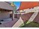 This outdoor patio is a delightful space with brick pavers, artificial turf, and a sun shade at 10938 W Pierson St, Phoenix, AZ 85037