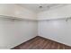 Empty walk-in closet with carpet flooring and shelves, awaiting your personal touch at 10938 W Pierson St, Phoenix, AZ 85037