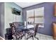 Eat-in dining area with a modern glass table, upholstered chairs, and a window for natural light at 1150 E Liberty Shores Dr, Gilbert, AZ 85234
