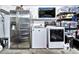 Garage setup with stainless refrigerator, washer/dryer, and shelving for storage at 1150 E Liberty Shores Dr, Gilbert, AZ 85234