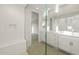 Modern bathroom featuring a glass shower, textured walls, and a double vanity at 13538 W Calle De Baca --, Peoria, AZ 85383