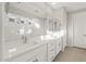 Bathroom featuring dual sinks, quartz countertop, and large mirror at 13538 W Calle De Baca --, Peoria, AZ 85383