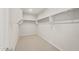 Walk-in closet featuring neutral carpet and multiple rows of shelving at 13538 W Calle De Baca --, Peoria, AZ 85383