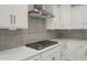 Close-up of a white kitchen with a stainless steel range hood and gray backsplash at 13538 W Calle De Baca --, Peoria, AZ 85383