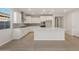 A modern white kitchen featuring an island, stainless steel appliances, and stylish backsplash at 13538 W Calle De Baca --, Peoria, AZ 85383