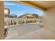 Covered back patio with stamped concrete, offering a view to other neighboring homes at 1358 E Angie St, Casa Grande, AZ 85122