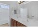 Bright bathroom featuring double sinks, a large mirror, and a shower-tub combo at 1358 E Angie St, Casa Grande, AZ 85122