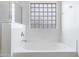 White tub featuring glass block window and chrome fixtures at 1358 E Angie St, Casa Grande, AZ 85122