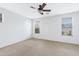 Spacious bedroom with a ceiling fan and large windows at 1358 E Angie St, Casa Grande, AZ 85122