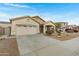 Inviting single-level home boasts a spacious driveway, two-car garage, and convenient front entrance at 1358 E Angie St, Casa Grande, AZ 85122