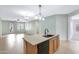 Open kitchen with a kitchen island extending into a living area, enhancing the space's functionality for dining and socializing at 1358 E Angie St, Casa Grande, AZ 85122