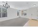 Bright and airy living room with large windows, neutral carpet, and tiled entrance offers versatile living at 1358 E Angie St, Casa Grande, AZ 85122