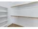 Bright walk-in closet with built-in shelving and wood rods for optimal storage at 1358 E Angie St, Casa Grande, AZ 85122