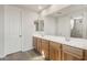 Bright bathroom features double vanity with wood cabinets, neutral countertops, large mirror, and walk-in shower at 13769 W Whisper Rock Trl, Peoria, AZ 85383