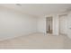 An empty bedroom with neutral carpet and a walk-in closet offers a blank slate ready for customization at 13769 W Whisper Rock Trl, Peoria, AZ 85383
