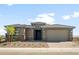 Charming single-story home featuring a two-car garage, desert landscaping, and stone accents at 13769 W Whisper Rock Trl, Peoria, AZ 85383