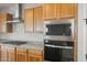 The kitchen boasts stainless steel appliances, granite countertops, and plenty of wooden cabinetry for storage at 13769 W Whisper Rock Trl, Peoria, AZ 85383