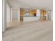 A spacious, open-concept kitchen with wooden cabinets and stainless steel appliances overlooks a large living area at 13769 W Whisper Rock Trl, Peoria, AZ 85383