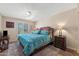 Comfortable bedroom with a ceiling fan, side tables, and natural light from the window at 1435 Leisure World --, Mesa, AZ 85206