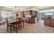 Open kitchen and dining area featuring tile floors, wood cabinets, and stainless steel appliances at 1435 Leisure World --, Mesa, AZ 85206