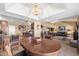 Open concept living room and dining area featuring tile floors, chandelier lighting, and comfortable seating at 1435 Leisure World --, Mesa, AZ 85206