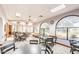 This meeting room includes multiple round tables and chairs with arched windows, providing natural light and a spacious area at 1435 Leisure World --, Mesa, AZ 85206