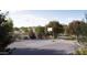 Outdoor community basketball court bordered by mature trees and landscaping offers recreational opportunities at 15032 W Gray Fox Trl, Surprise, AZ 85387