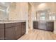 Bathroom with dual vanity featuring granite counters and wood-look floors and walk-in shower at 15032 W Gray Fox Trl, Surprise, AZ 85387